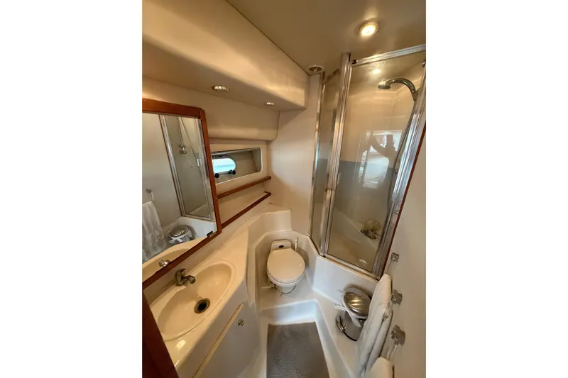 B Liner Yacht Photos Pics 1998 Bayliner 4788 Pilot House Motoryacht bathroom with shower, sink, and toilet.