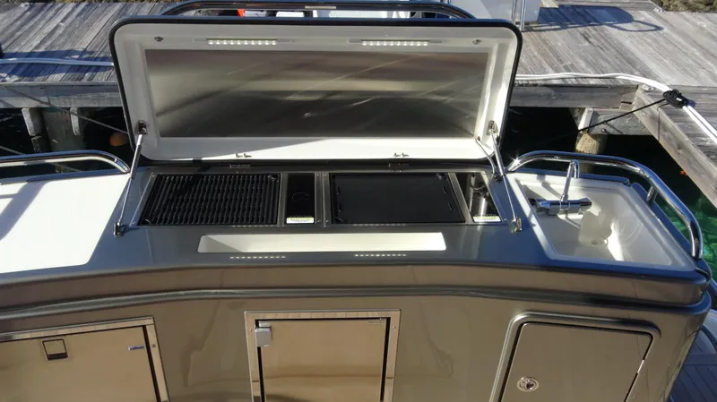 Chapter II Yacht Photos Pics 2023 Riviera 6000 Sport Yacht outdoor kitchen with grill and sink.