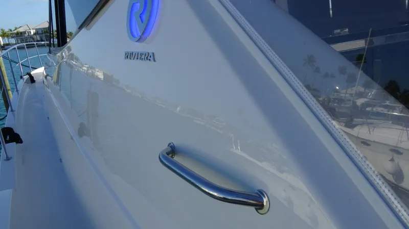 Chapter II Yacht Photos Pics 2023 Riviera 6000 Sport Yacht side view with logo and handle.