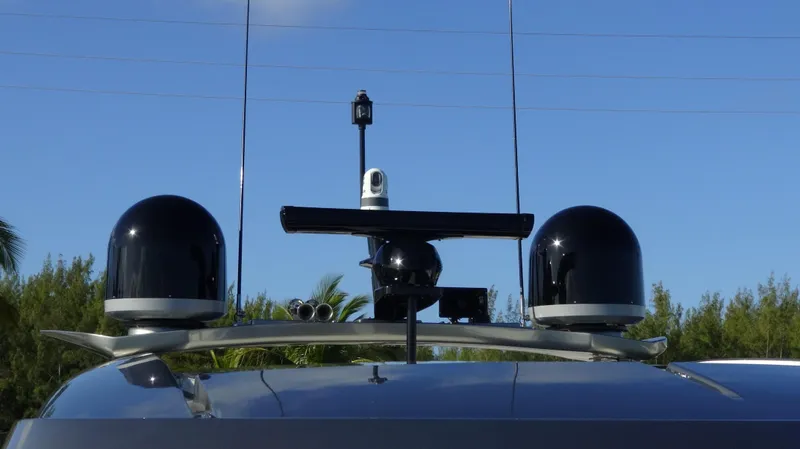Chapter II Yacht Photos Pics Riviera 6000 Sport Yacht 2023 radar and communication equipment against blue sky.