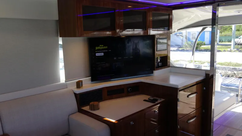 Chapter II Yacht Photos Pics Luxurious interior of 2023 Riviera 6000 Sport Yacht with modern entertainment system.