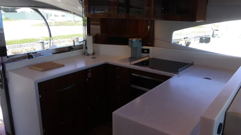 Chapter II Yacht Photos Pics 2023 Riviera 6000 Sport Yacht kitchen with modern appliances and sleek design.
