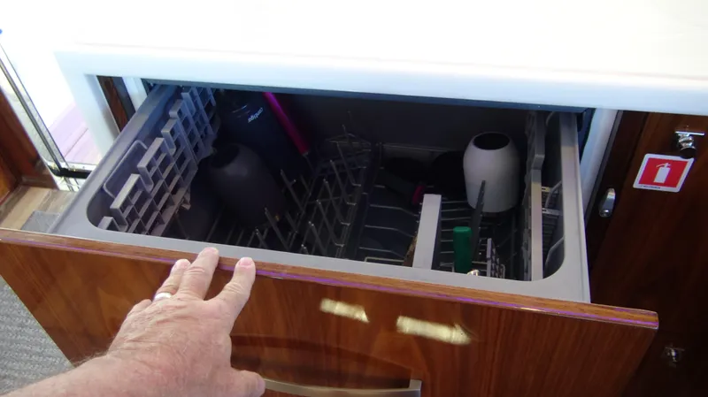 Chapter II Yacht Photos Pics Open dishwasher drawer in 2023 Riviera 6000 Sport Yacht kitchen area.