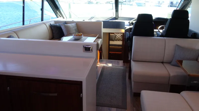 Chapter II Yacht Photos Pics Interior of 2023 Riviera 6000 Sport Yacht with luxurious seating and helm.