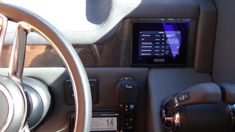 Chapter II Yacht Photos Pics 2023 Riviera 6000 Sport Yacht dashboard with steering wheel and control panel.