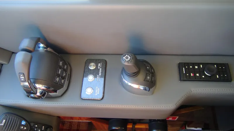 Chapter II Yacht Photos Pics Control panel of 2023 Riviera 6000 Sport Yacht with joystick and throttle controls.