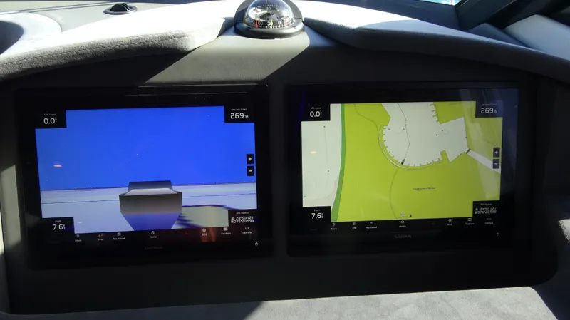 Chapter II Yacht Photos Pics Dashboard of 2023 Riviera 6000 Sport Yacht with navigation screens displaying maps and data.