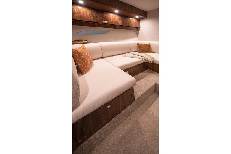 Chapter II Yacht Photos Pics 2023 Riviera 6000 Sport Yacht interior with plush seating and elegant wood finishes.