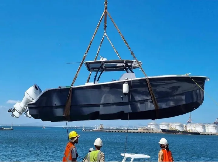 Hull 136 Yacht Photos Pics 2025 Hammer Yachts HammerCat 35 being lifted by crane at a harbor.