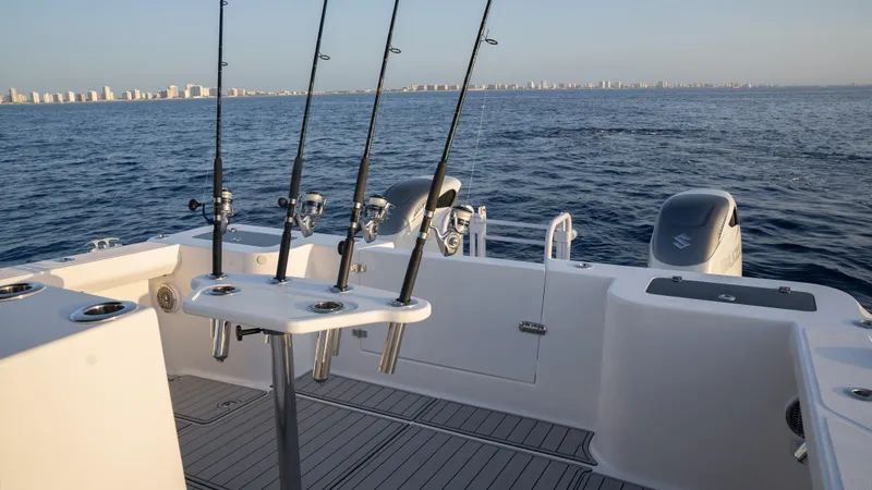 Hull 136 Yacht Photos Pics 2025 Hammer Yachts HammerCat 35 with fishing rods, ocean view, and city skyline in the background.