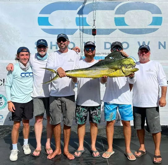 Hull 136 Yacht Photos Pics Group of fishermen holding a large fish at a fishing event, HammerCat 35, 2025.