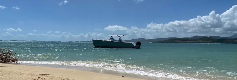 Hull 136 Yacht Photos Pics 2025 Hammer Yachts HammerCat 35 on turquoise sea near sandy beach.