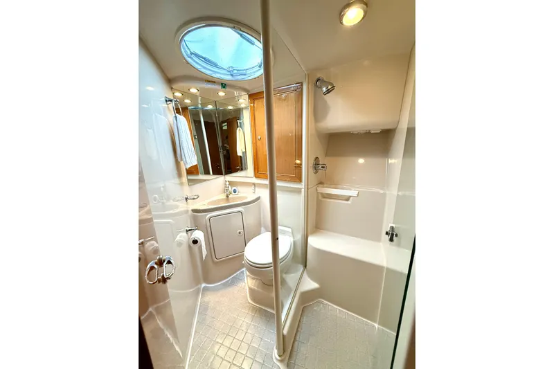 Golden Rule Yacht Photos Pics Luxurious bathroom in 2006 Riviera 42 Flybridge yacht with modern fixtures and skylight.