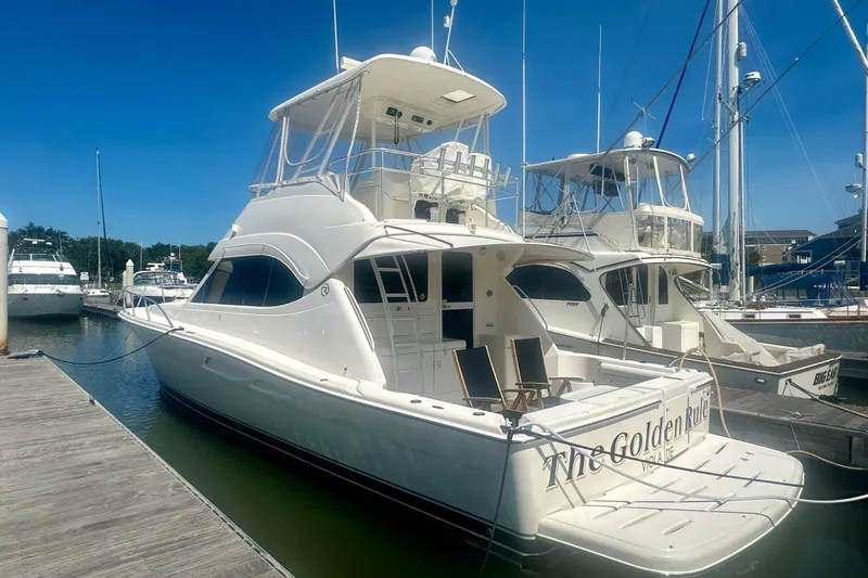 Golden Rule Yacht Photos Pics 2006 Riviera 42 Flybridge yacht docked at marina under clear blue sky.