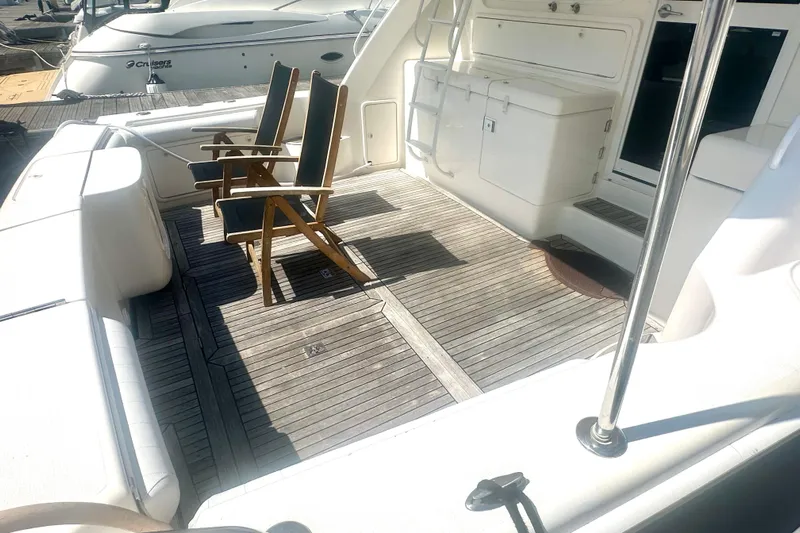 Golden Rule Yacht Photos Pics 2006 Riviera 42 Flybridge yacht deck with wooden chairs and storage compartments.
