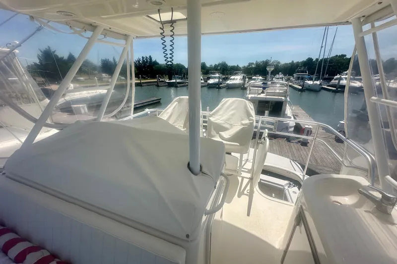 Golden Rule Yacht Photos Pics Flybridge view of 2006 Riviera 42 yacht docked at marina with surrounding boats.