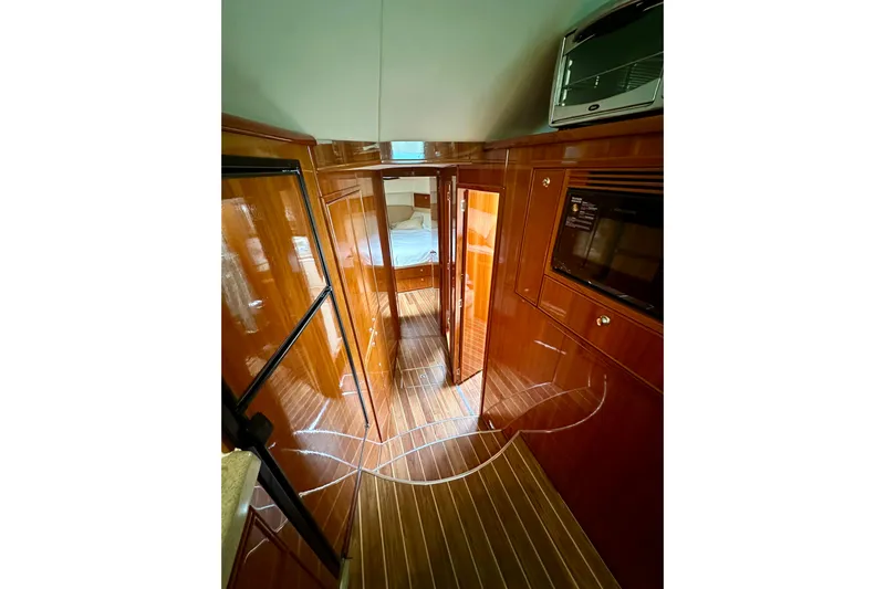 Golden Rule Yacht Photos Pics Luxurious interior of 2006 Riviera 42 Flybridge yacht with polished wood finishes.