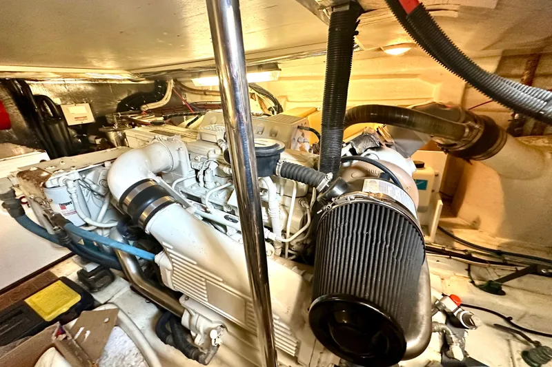 Golden Rule Yacht Photos Pics Engine room of a 2006 Riviera 42 Flybridge yacht, showcasing detailed machinery and components.