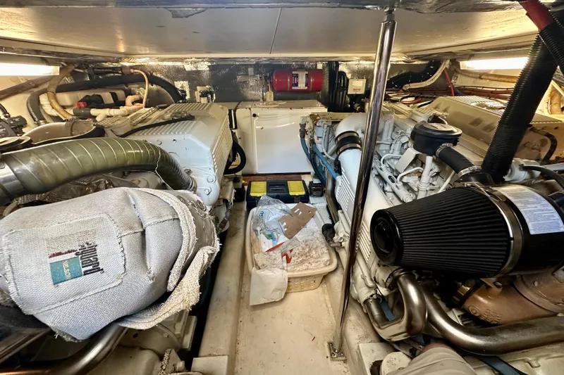 Golden Rule Yacht Photos Pics Engine room of 2006 Riviera 42 Flybridge yacht, showcasing dual engines and mechanical components.