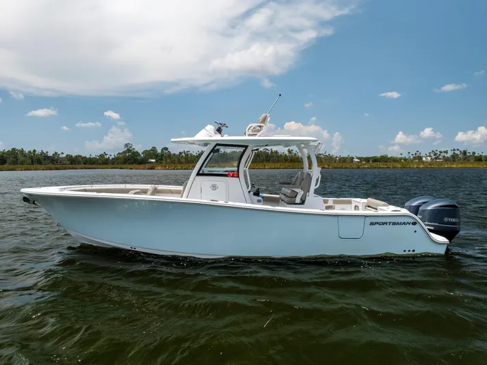  Yacht Photos Pics 2021 Sportsman Open 302 Center Console boat on calm water under a clear sky.