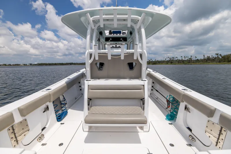  Yacht Photos Pics 2021 Sportsman Open 302 Center Console boat on calm water under cloudy sky.
