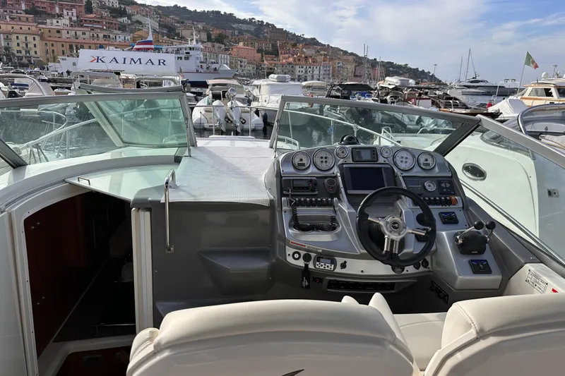 Key West Yacht Photos Pics 2011 Monterey 315 SCR boat dashboard with steering wheel, docked in a scenic marina.
