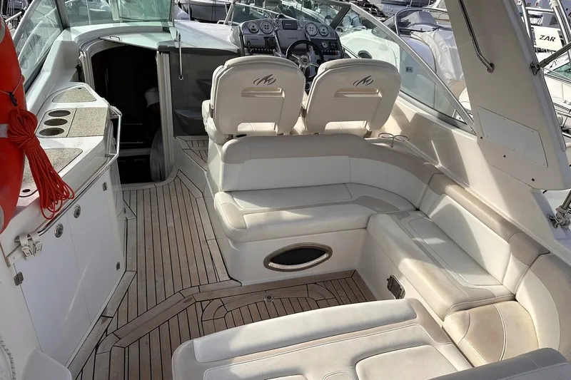 Key West Yacht Photos Pics Luxurious interior of a 2011 Monterey 315 SCR boat with plush seating and modern dashboard.