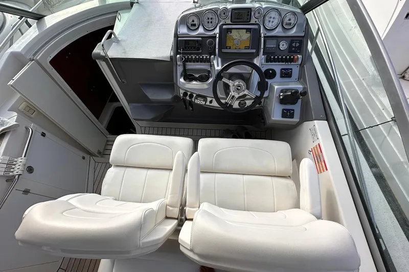 Key West Yacht Photos Pics Cockpit of 2011 Monterey 315 SCR boat with dual white seats and control panel.