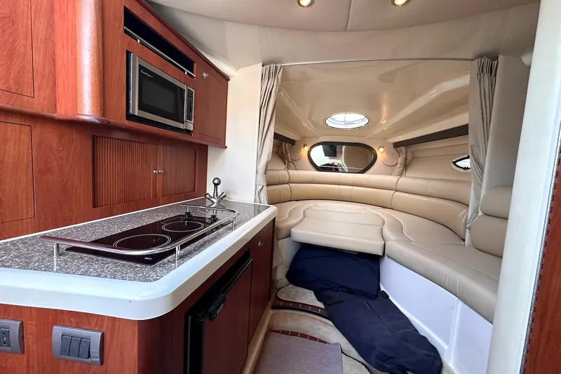 Key West Yacht Photos Pics Luxurious interior of 2011 Monterey 315 SCR boat with kitchenette and cozy seating area.