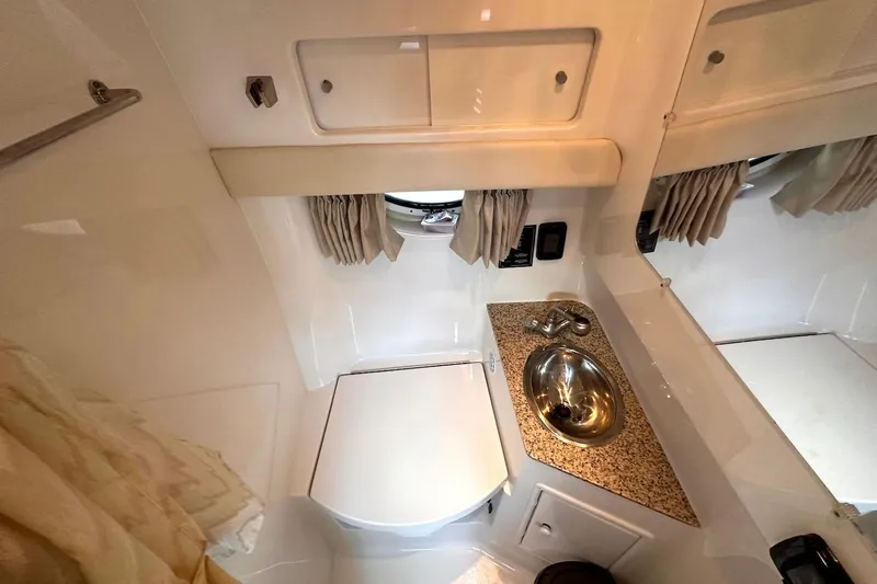 Key West Yacht Photos Pics 2011 Monterey 315 SCR bathroom with sink, toilet, and storage cabinets.