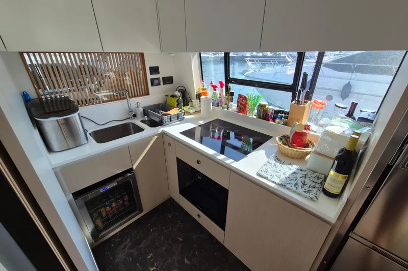  Yacht Photos Pics Modern kitchen in 2023 Azimut Fly 68 yacht with sleek design and appliances.