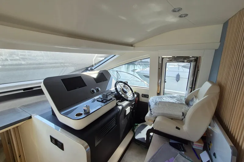  Yacht Photos Pics Interior helm of 2023 Azimut Fly 68 yacht, featuring modern controls and luxurious seating.