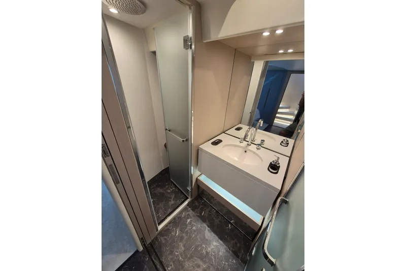  Yacht Photos Pics Luxurious bathroom in 2023 Azimut Fly 68 yacht with modern fixtures and elegant design.