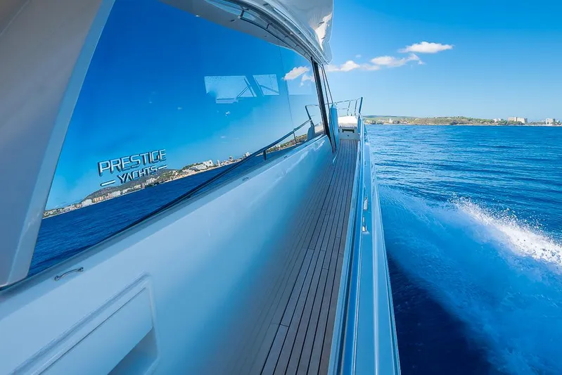  Yacht Photos Pics Prestige 680 yacht cruising on blue ocean, reflecting clear sky, 2017 model.