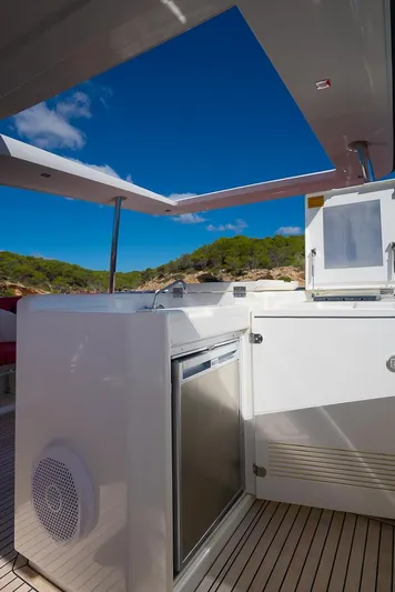  Yacht Photos Pics Luxury yacht deck with modern amenities, Prestige 680, 2017 model, under clear blue sky.