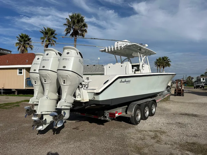  Yacht Photos Pics 2011 SeaHunter Center Console boat with triple outboard engines on a trailer.