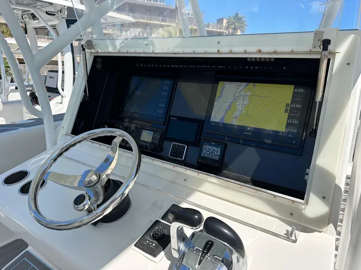  Yacht Photos Pics 2011 SeaHunter Center Console boat dashboard with navigation screens and steering wheel.