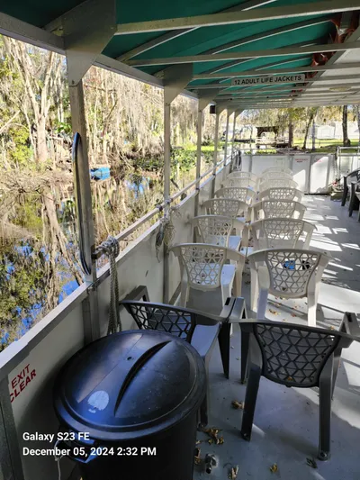 Sweet Tea Yacht Photos Pics 2016 Commercial Rover Marine Carolina Rover 40 boat with seating, docked by a scenic river.