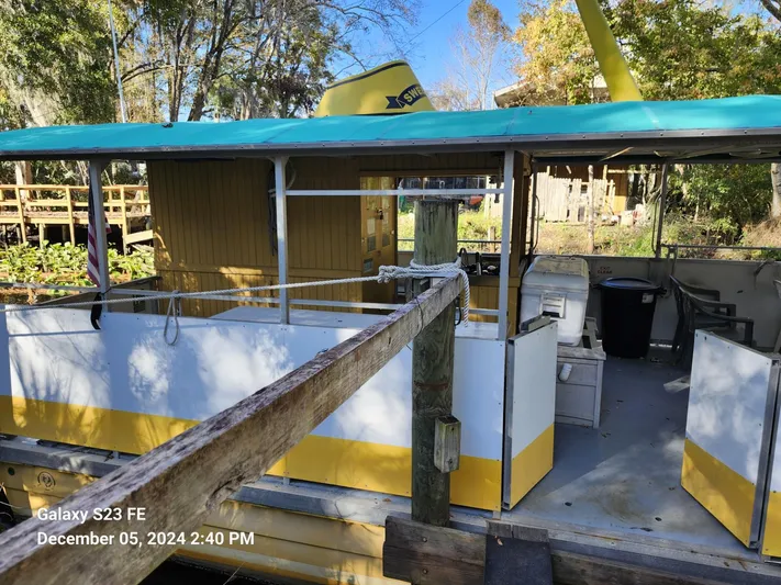 Sweet Tea Yacht Photos Pics 2016 Rover Marine Carolina Rover 40 docked, featuring open deck and vibrant yellow accents.