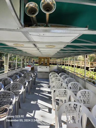 Sweet Tea Yacht Photos Pics Interior of 2016 Rover Marine Carolina Rover 40 with white chairs and green canopy.