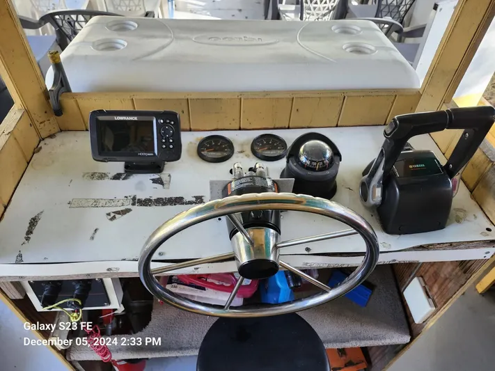 Sweet Tea Yacht Photos Pics Control panel of 2016 Rover Marine Carolina Rover 40 with steering wheel and navigation equipment.