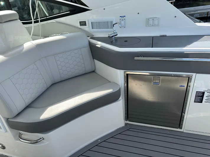  Yacht Photos Pics 2020 Sea Ray Sundancer 320 interior with seating and kitchenette area.