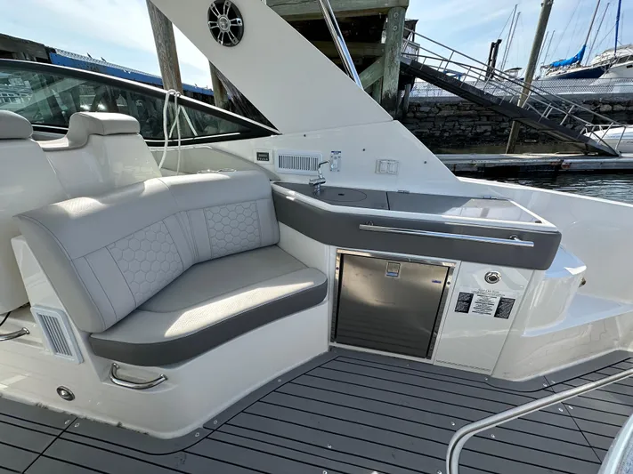  Yacht Photos Pics 2020 Sea Ray Sundancer 320 yacht interior with seating and kitchenette.