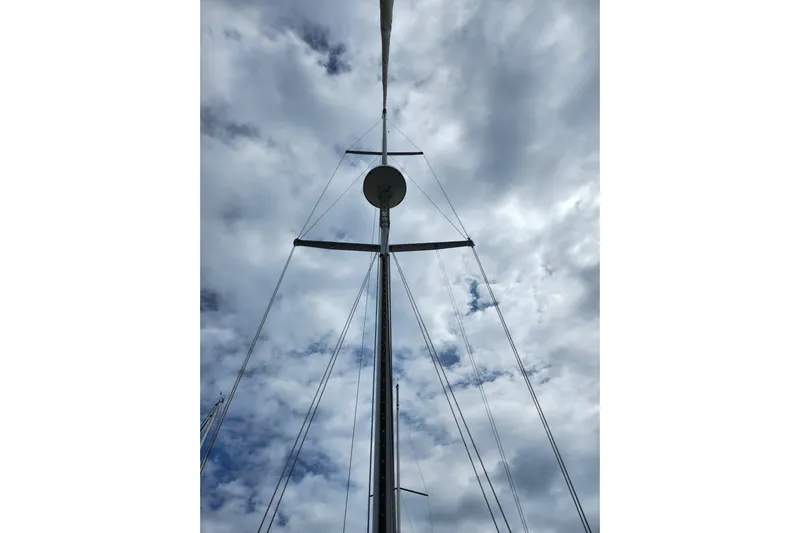 Isola Bella Yacht Photos Pics Mast of 1988 Sabre 42 sailboat against cloudy sky.