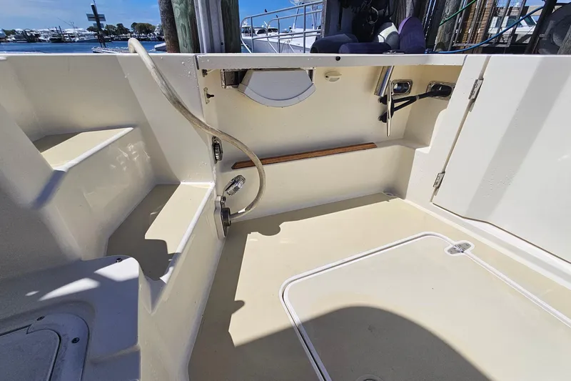  Yacht Photos Pics 2009 Sabre 42 Express boat deck with storage and hose, docked at marina.