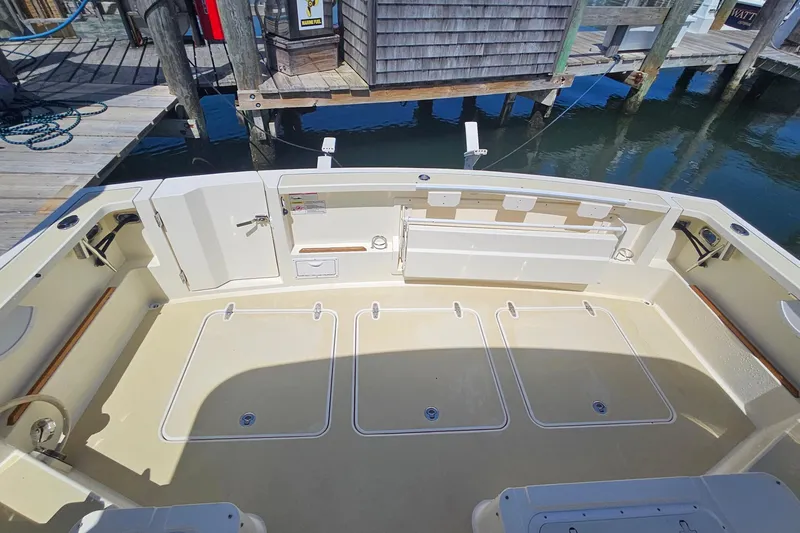  Yacht Photos Pics 2009 Sabre 42 Express boat deck with storage compartments and dock view.