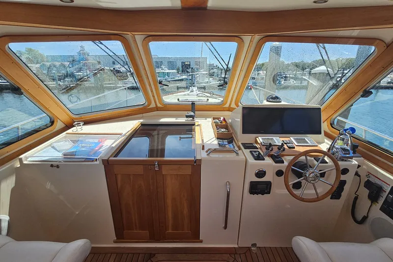  Yacht Photos Pics 2009 Sabre 42 Express helm with wooden accents and modern navigation equipment.