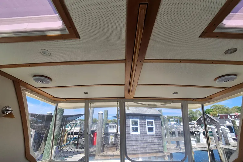  Yacht Photos Pics Interior view of 2009 Sabre 42 Express yacht with wooden ceiling and dockside scenery.