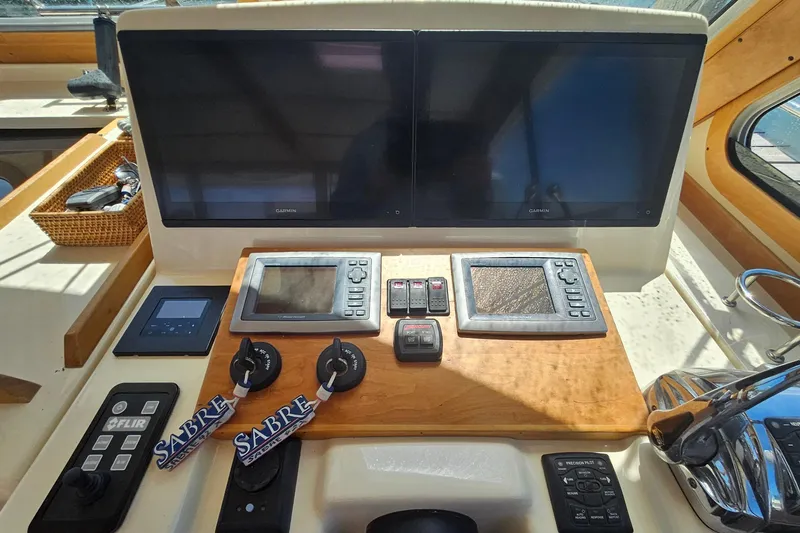  Yacht Photos Pics 2009 Sabre 42 Express helm with dual Garmin displays and navigation controls.