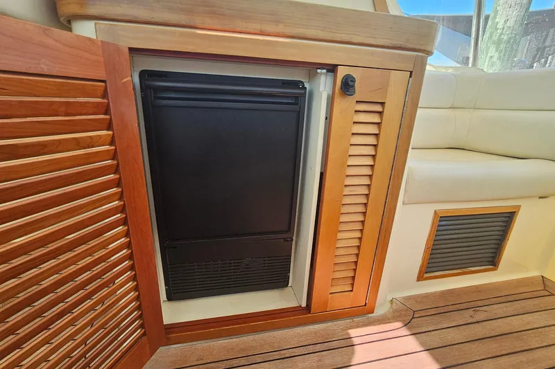 Yacht Photos Pics 2009 Sabre 42 Express interior with wooden cabinetry and built-in refrigerator.